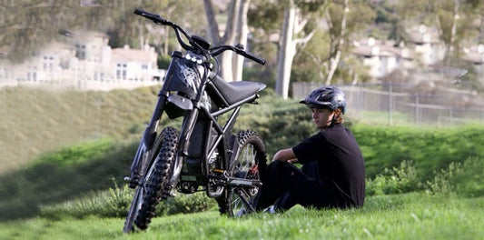 A boy sitting beside his GT73 highlighting the ease and adventure of transporting an e-bike for travel.