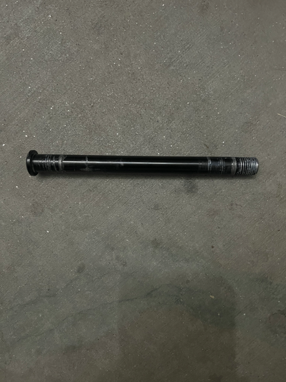 Front axle bolt and nut for GT73 on a concrete surface.